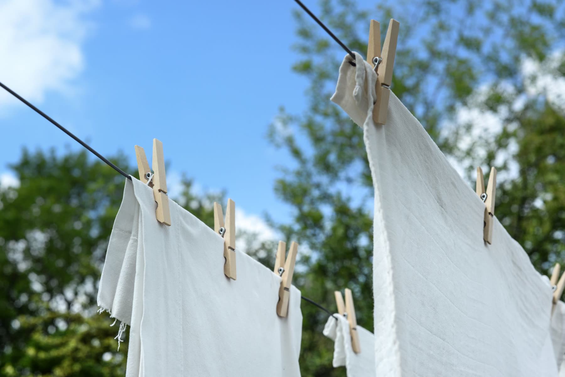 White linen drying on a clothesline outdoors
